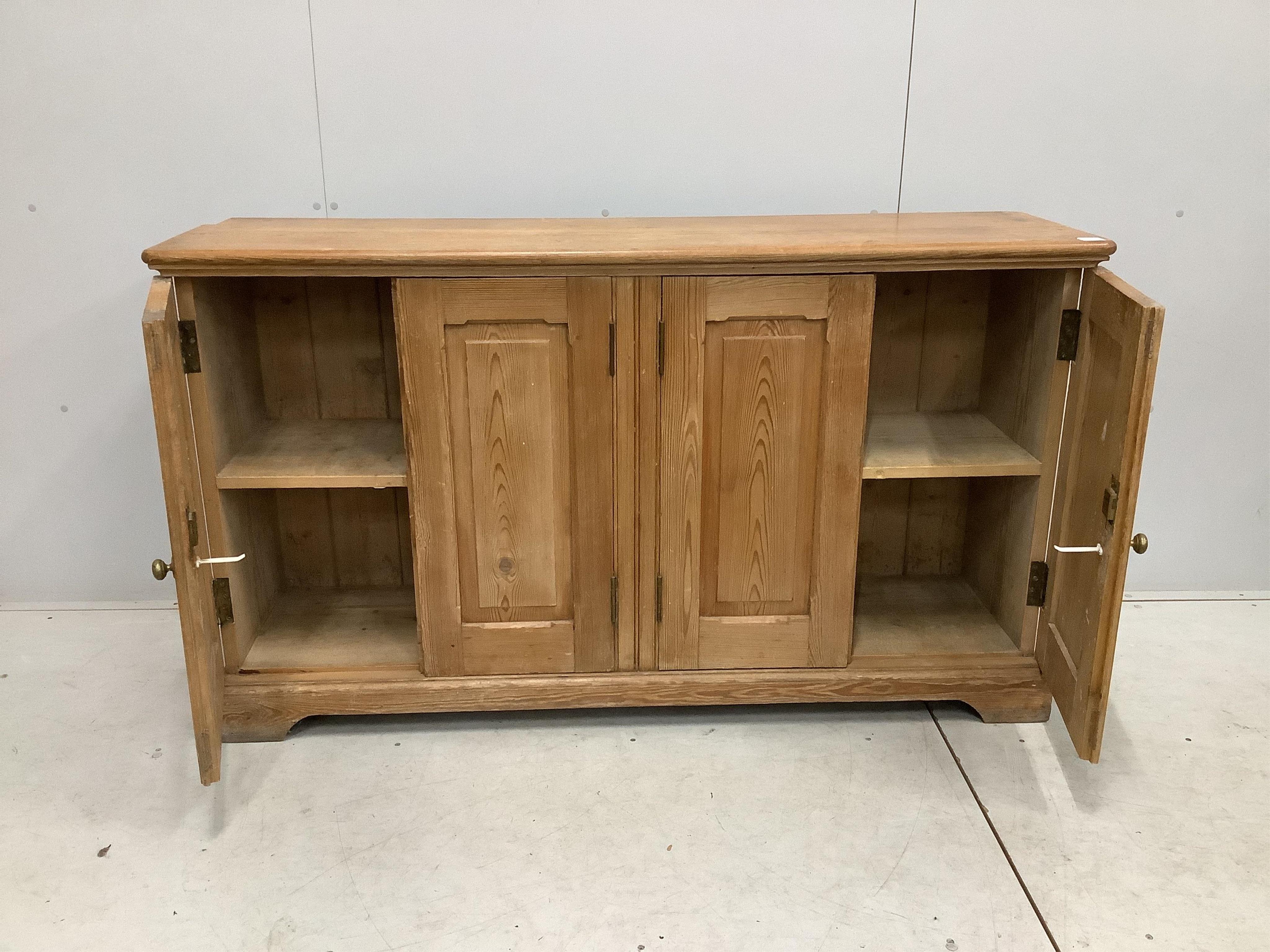A late Victorian pitch pine four door side cabinet, width 158cm, depth 42cm, height 91cm. Condition - fair